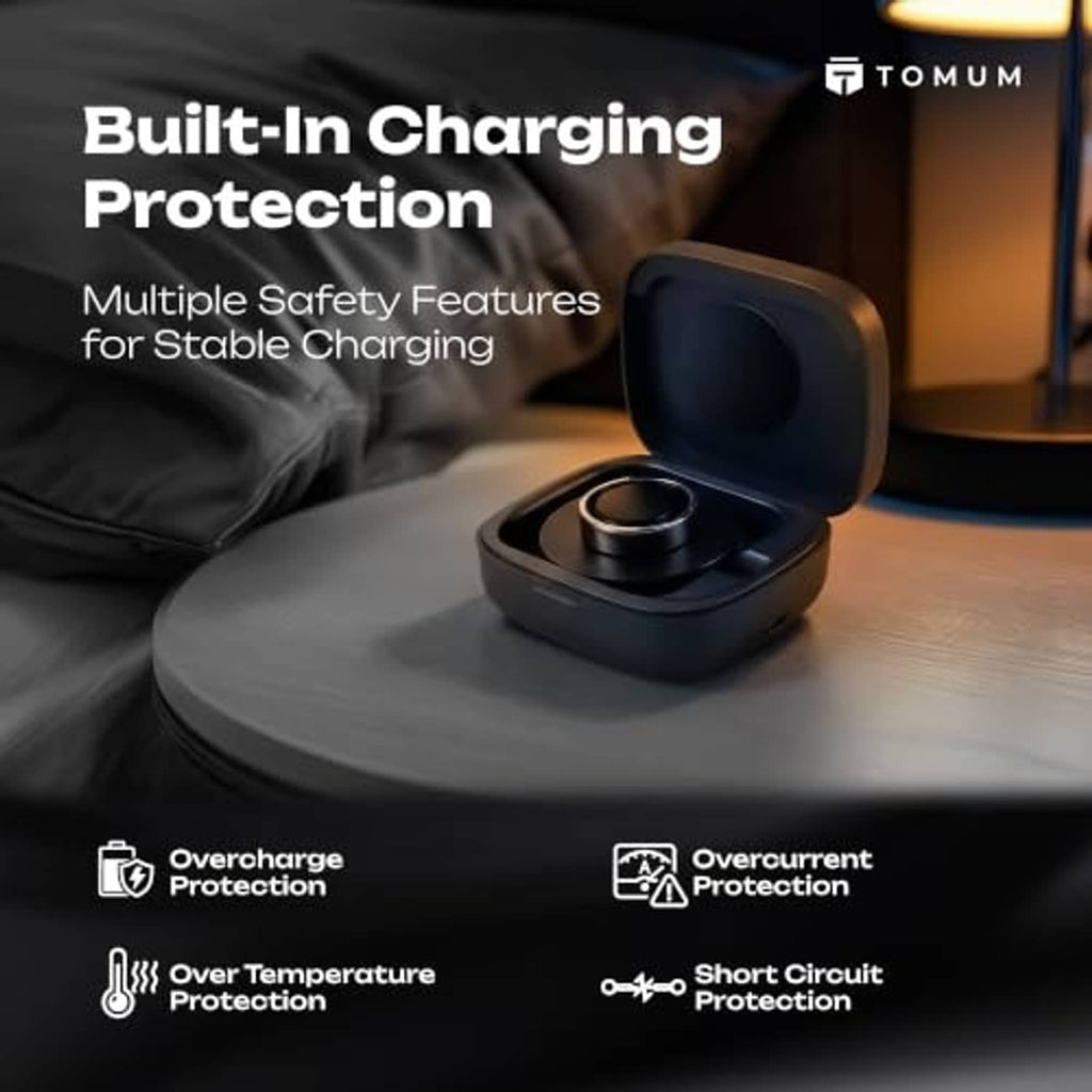 Dark gray charging case open on tabletop, showing circular ring charger