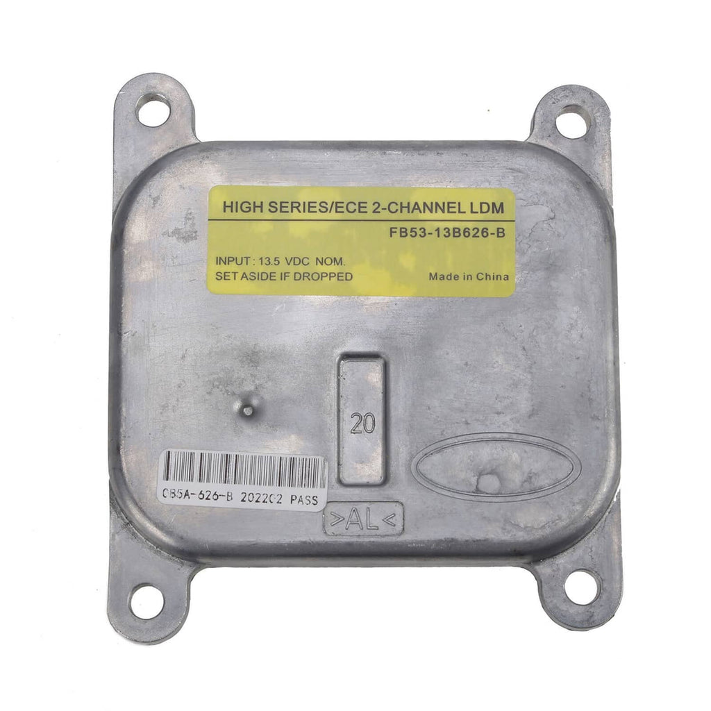 LED headlight control module with yellow label, metal casing, and four mounting holes