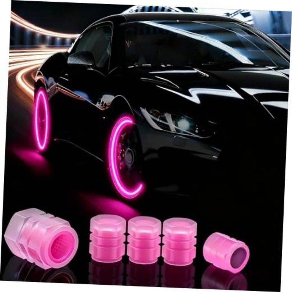 Set of pink glow-in-the-dark tire valve caps next to a car wheel and fender
