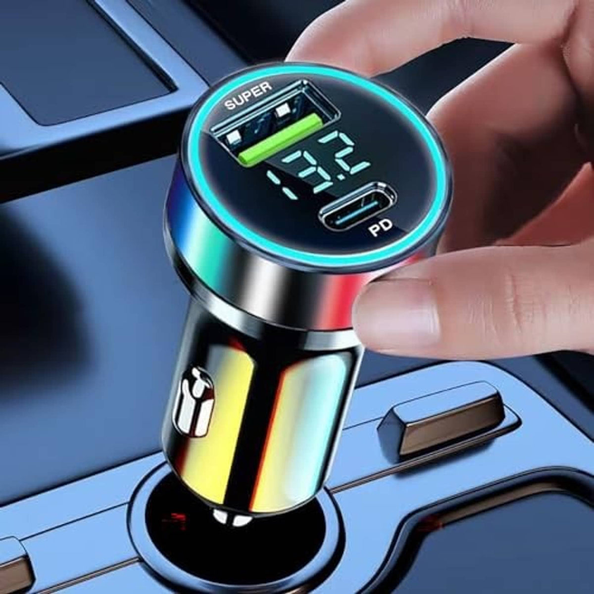 Car USB-C charger adapter held near dashboard, circular LED voltage display lit