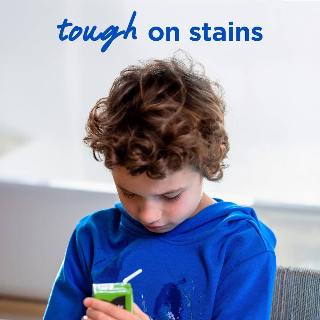 Child holding Purex detergent pac with “tough on stains” text overhead
