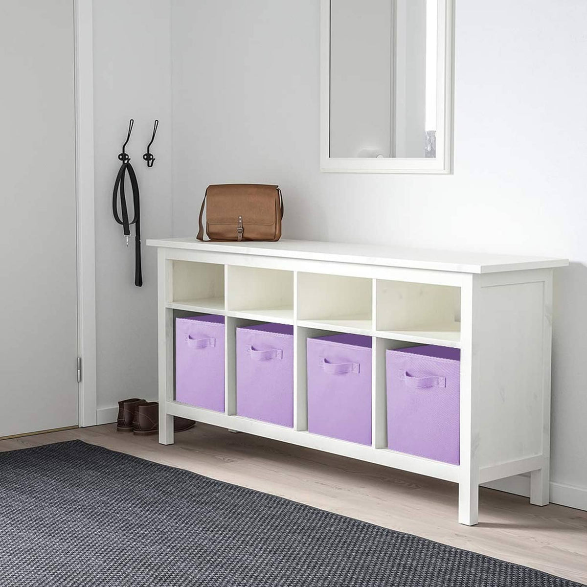 Lavender fabric storage cube bins with front pull handles under a console table