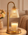 Gold candle warmer lamp with lattice glass shade and brass base, warming a jar candle