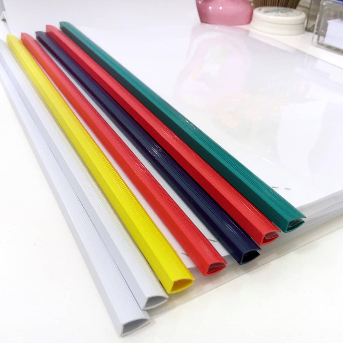 Assorted slide-grip binding bars in multiple colors, neatly bundled on a tray
