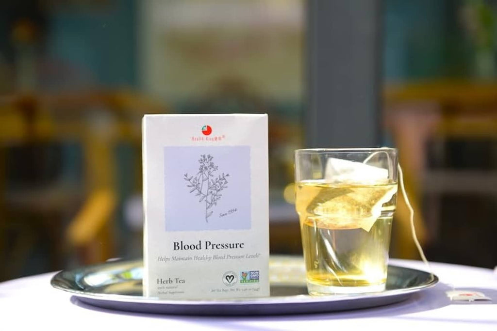 Blood Pressure herb tea box beside glass mug of tea.