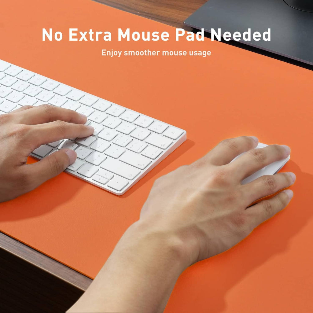 Orange leather desk pad protector on desk surface, hands smoothing the mat