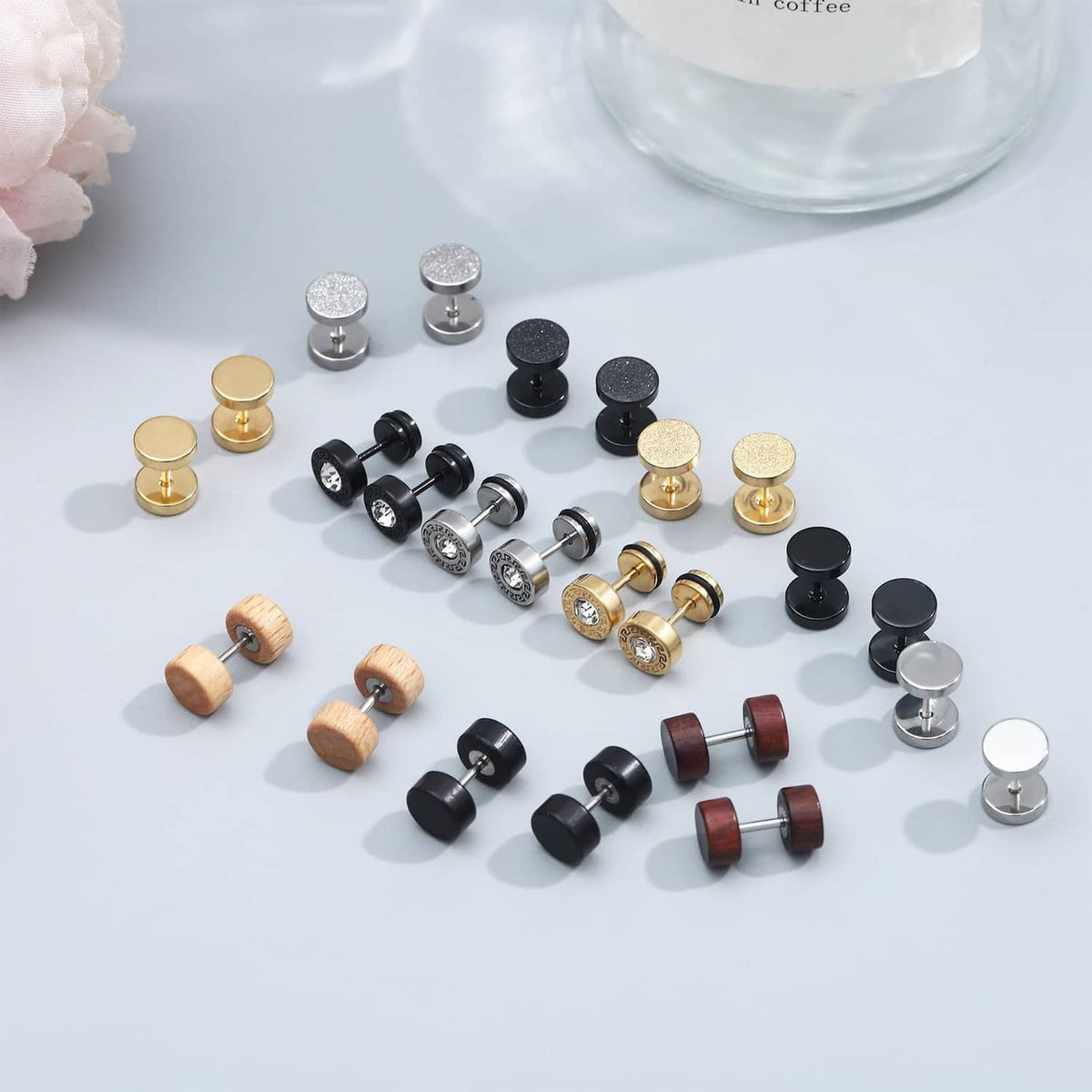Round stud earring set in black, silver, gold, brown, and faux stone finishes