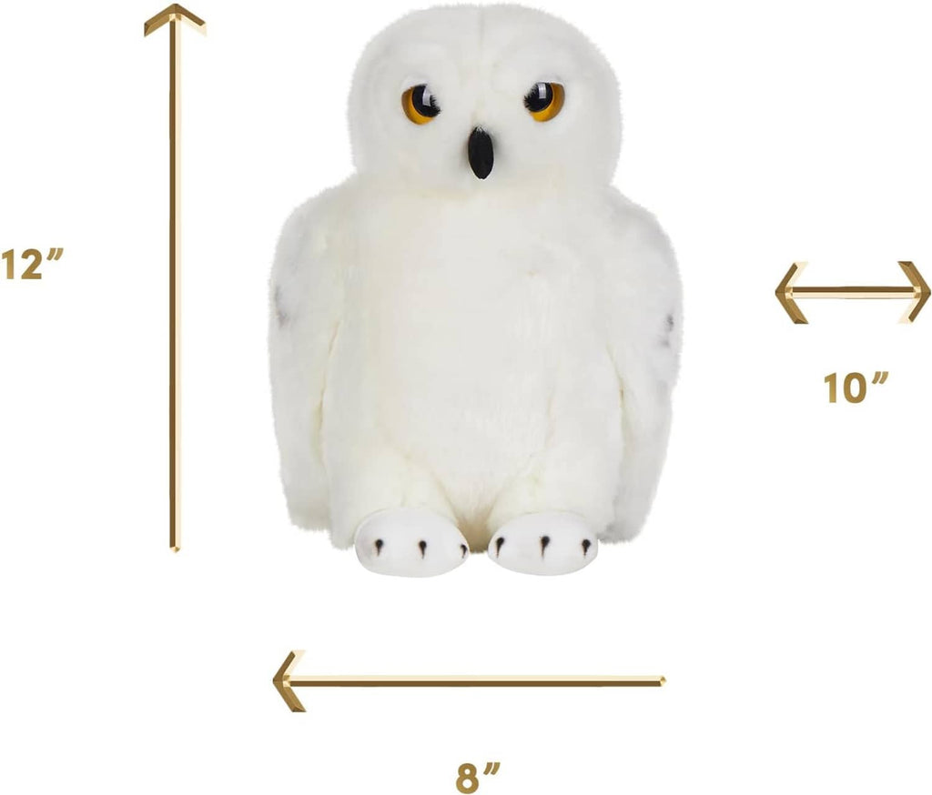 Large plush snowy owl toy with white fur, amber eyes, and a black beak
