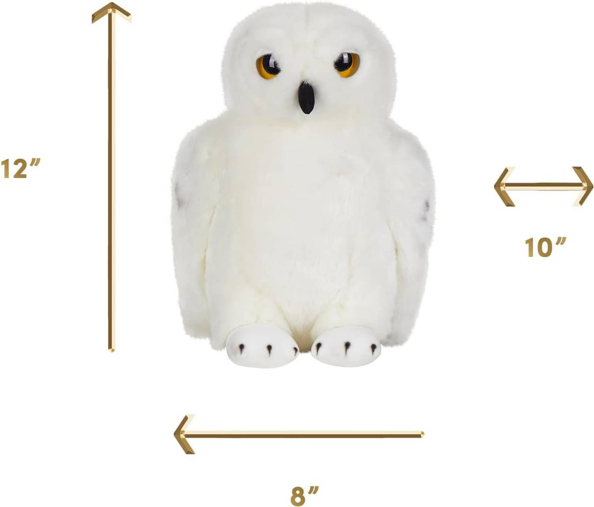 Large plush snowy owl toy with white fur, amber eyes, and a black beak