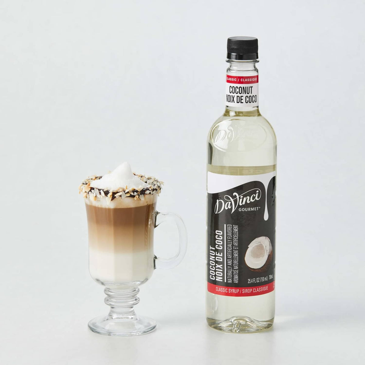 DaVinci Gourmet coconut syrup bottle with coconut-topped latte in a glass