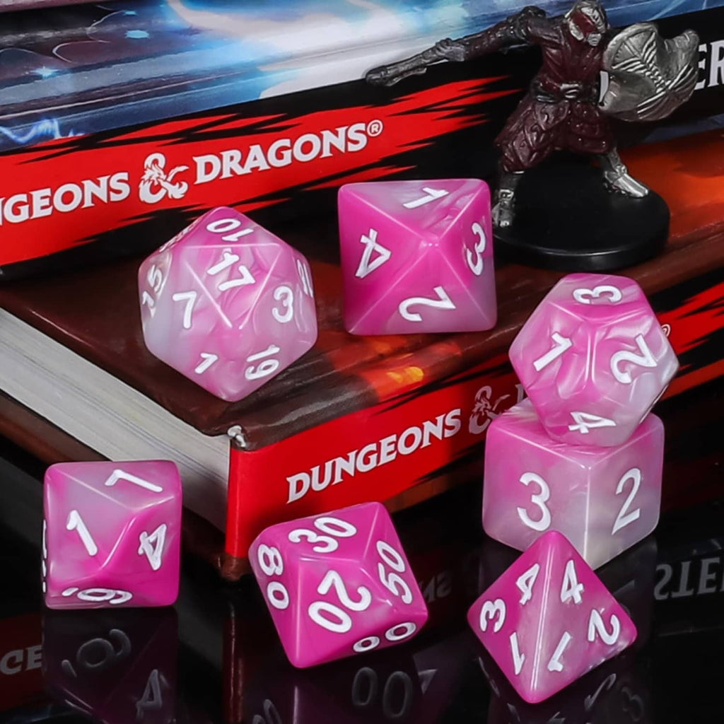 Pink polyhedral dice on a Dungeons & Dragons box, with white number faces