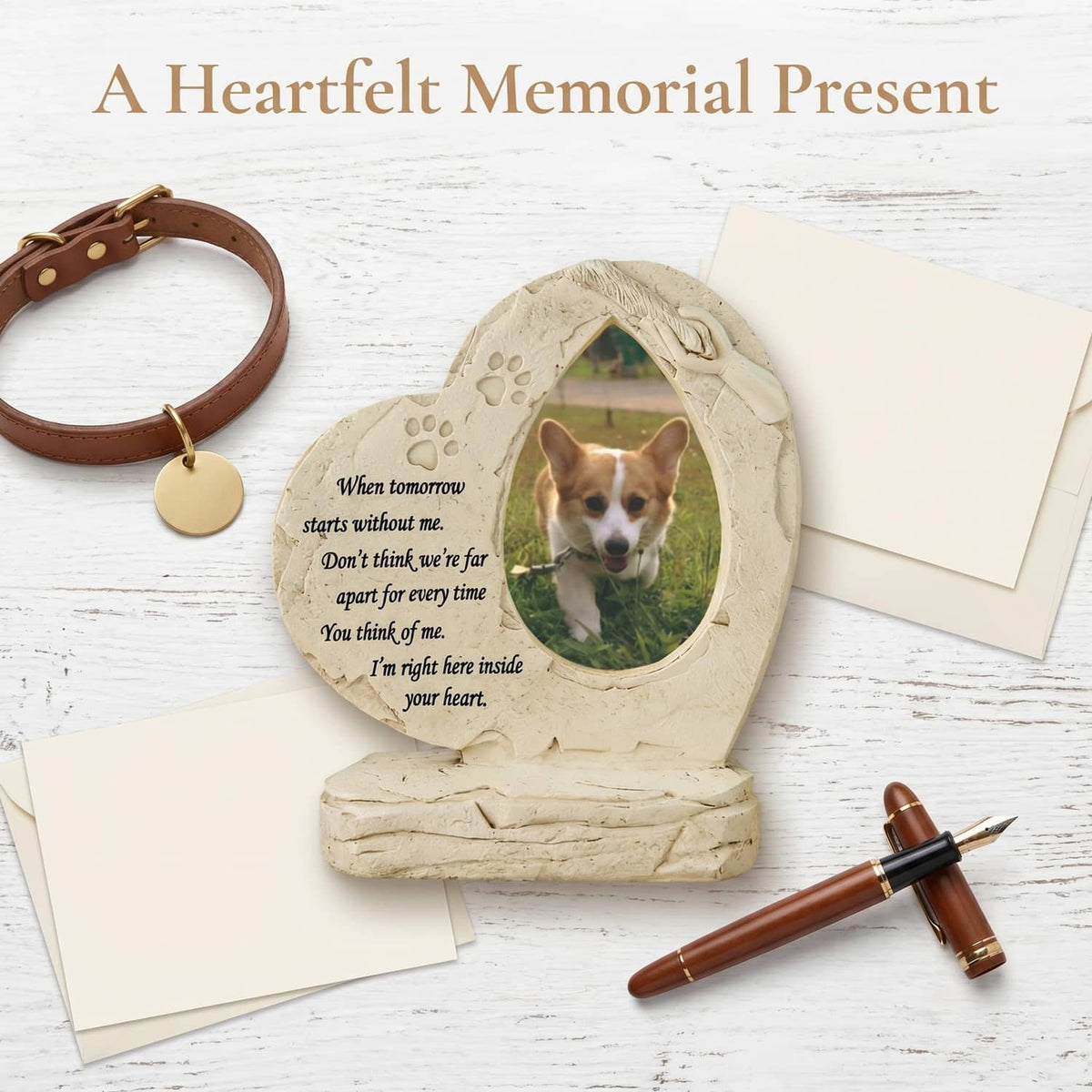 White heart-shaped dog memorial stone with oval photo window and paw-print border