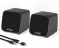 Pair of compact black desktop speakers with USB cable and 3.5mm adapter