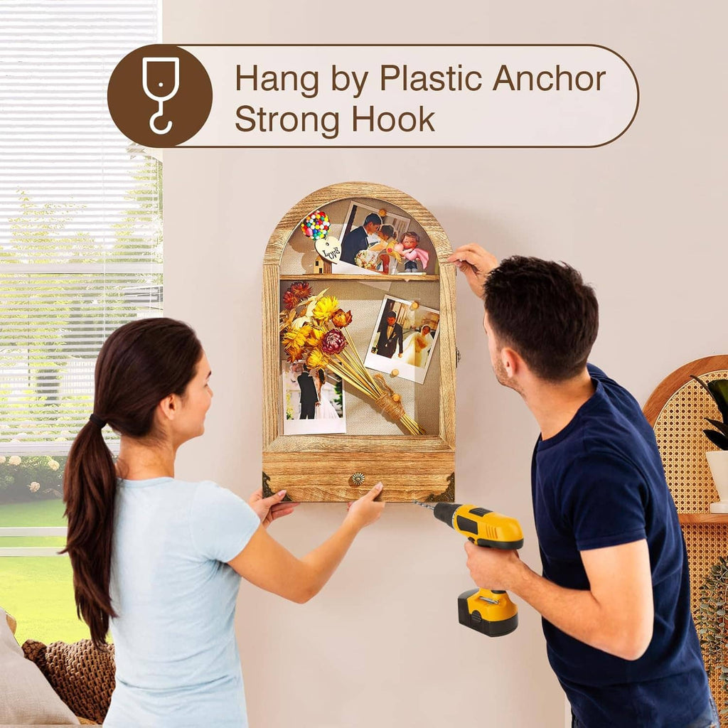 Arched shadow box frame mounted using a plastic anchor and strong hook