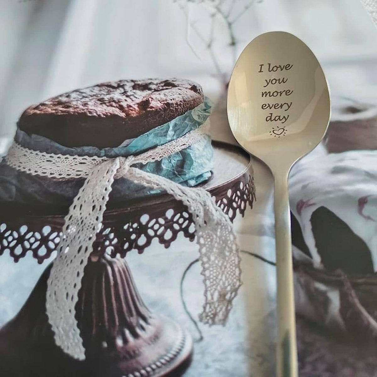 Engraved love message spoon with oval beige bowl and silver handle, 'I love you more every day'