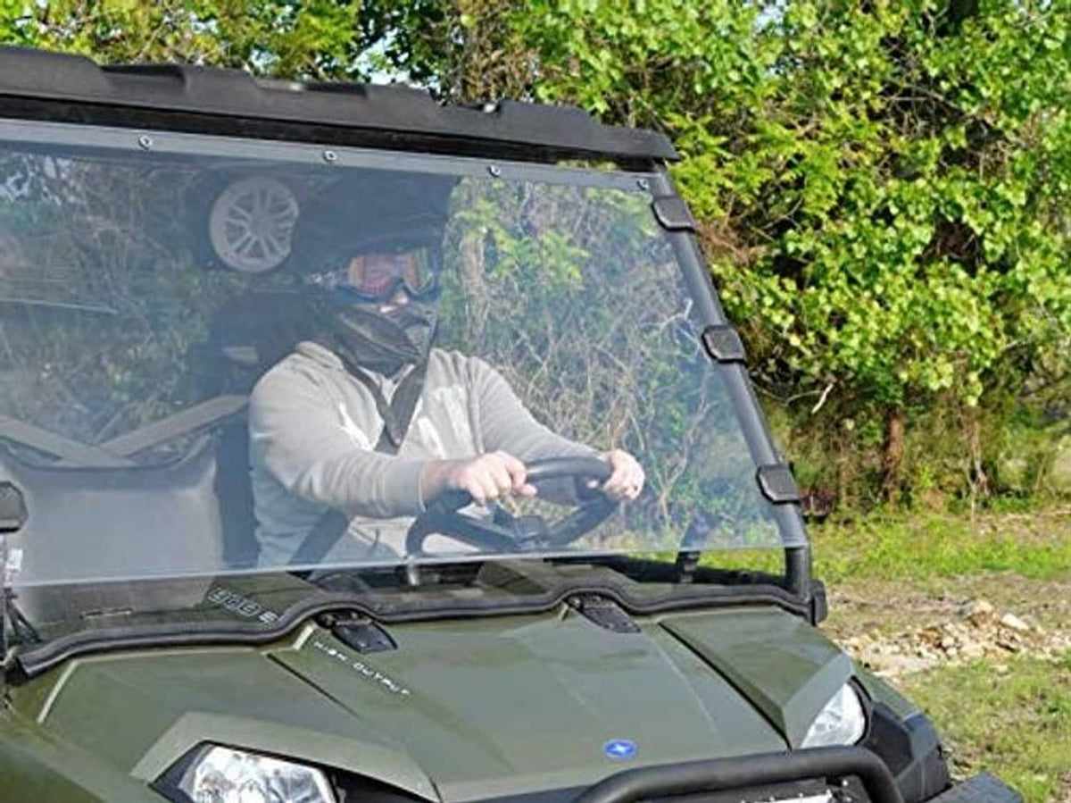 Close view of clear full UTV windshield with black frame and side latch points
