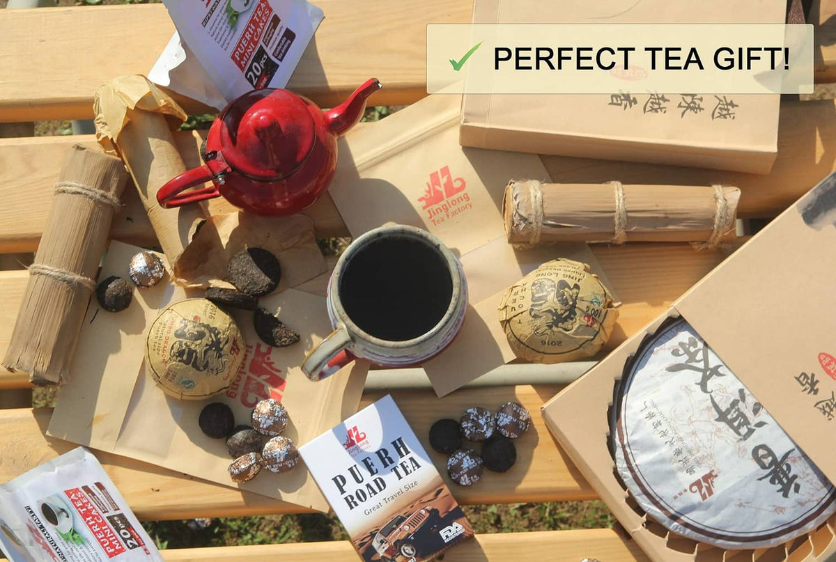 Pu-erh tea set with bamboo leaf tube, tea tablets, and cups on gift tray