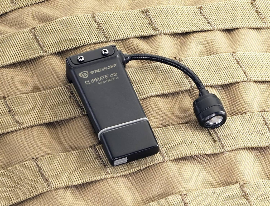 ClipMate light clipped onto tan tactical fabric with connected cable loop