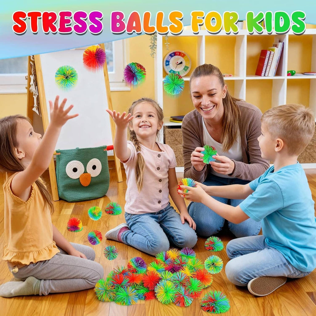 Rainbow stringy pom stress balls on the floor, kids holding colorful fidgets