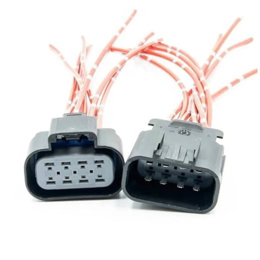 Headlight wiring connector pigtail pair with gray housings and red-striped leads, angled