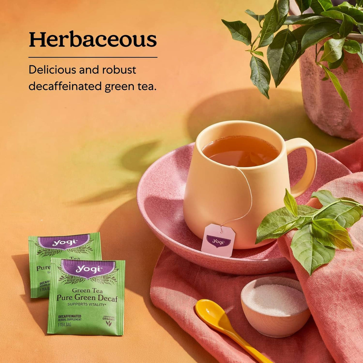 Yogi green tea decaf tea cup and small yellow tea packet