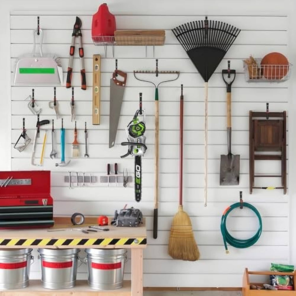 Multiple black wall hooks with red end caps mounted on a tool organizer board