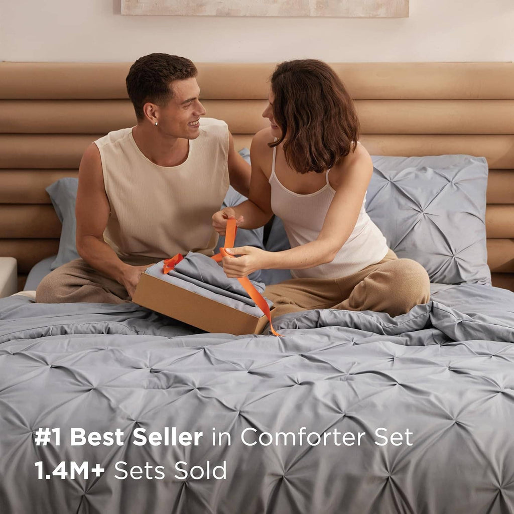 Grey queen comforter set with tufted pinch-pleat quilting, styled on bed