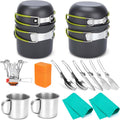 Black camping cookware set with two stackable pots, utensils, stove, and orange storage case