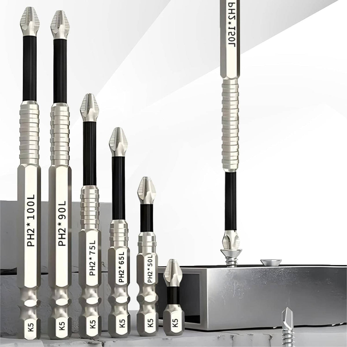 Magnetic bit set standing near a metal tray, black shafts with silver ribbed tips