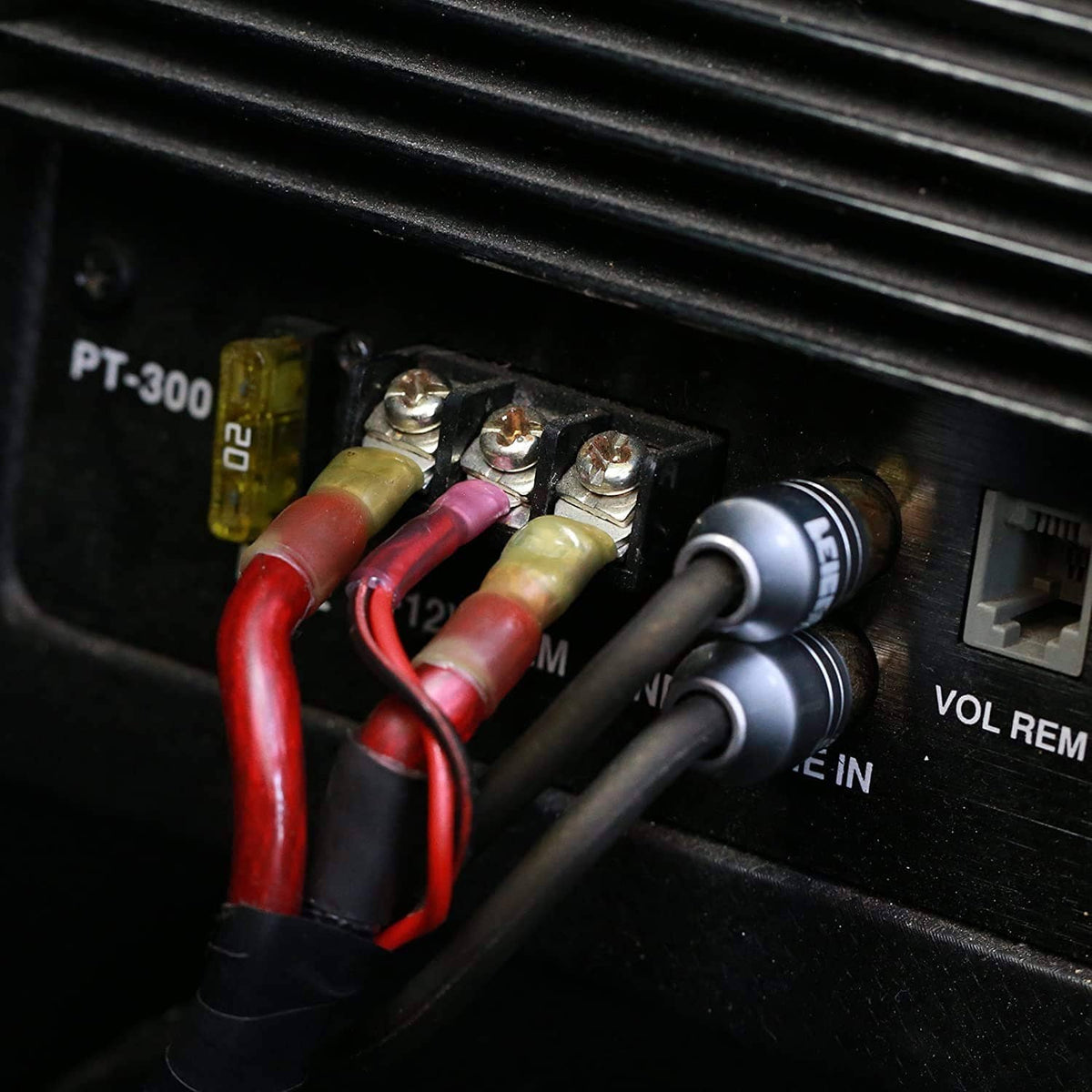 Insulated crimp wire connectors on vehicle wiring, with red and yellow heat-shrink sleeves