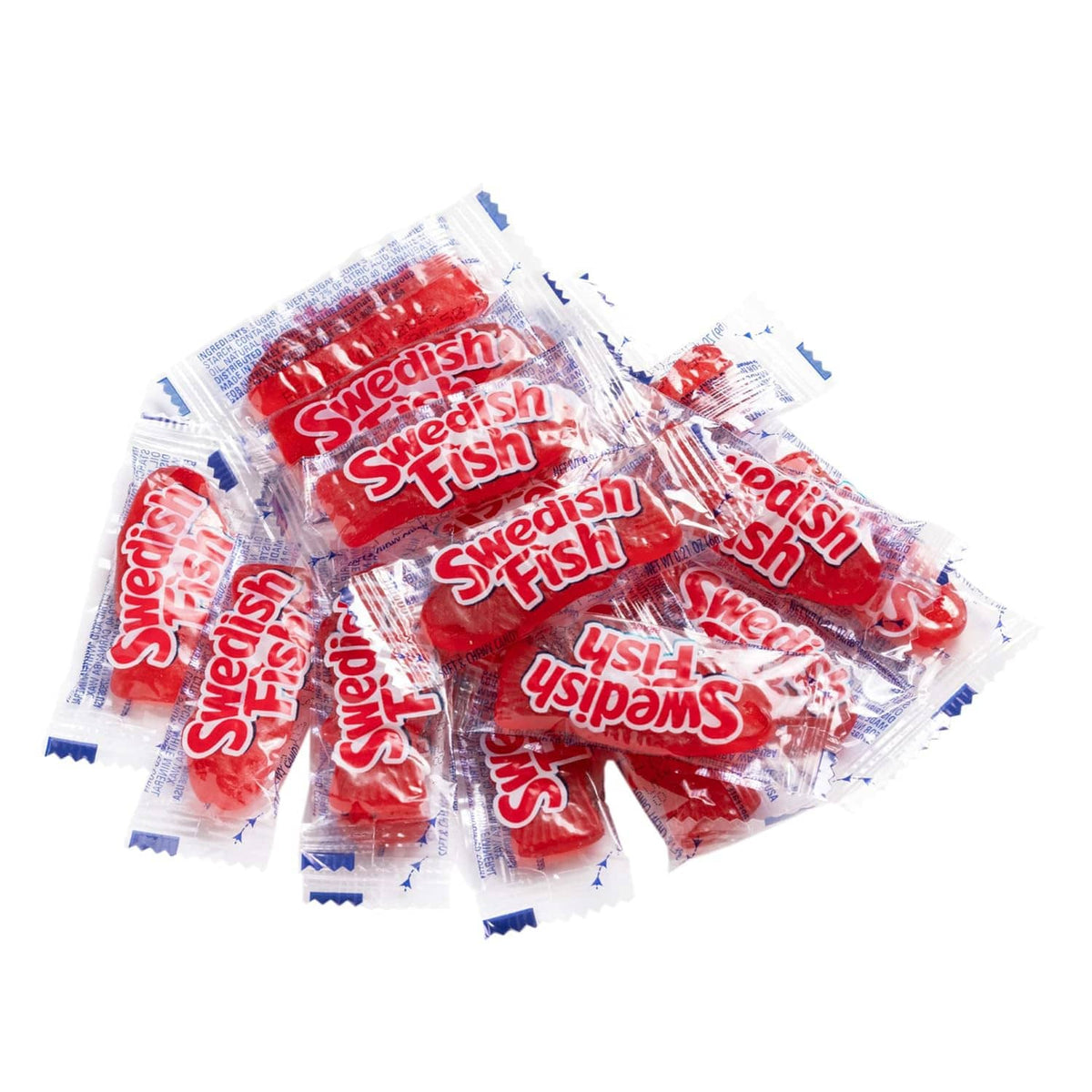 Individually wrapped Swedish Fish red gummies, mixed pile in clear wrappers