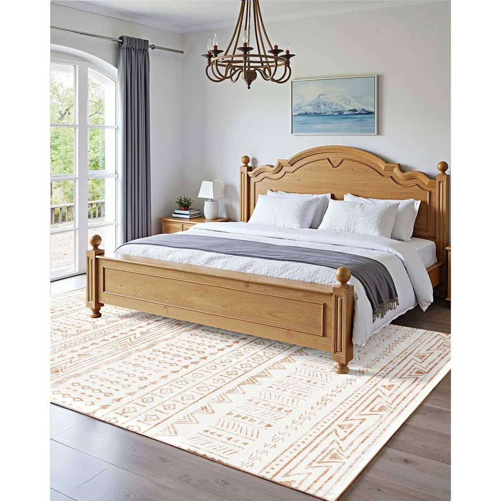 Beige geometric area rug with brown diamond and chevron designs under a bed