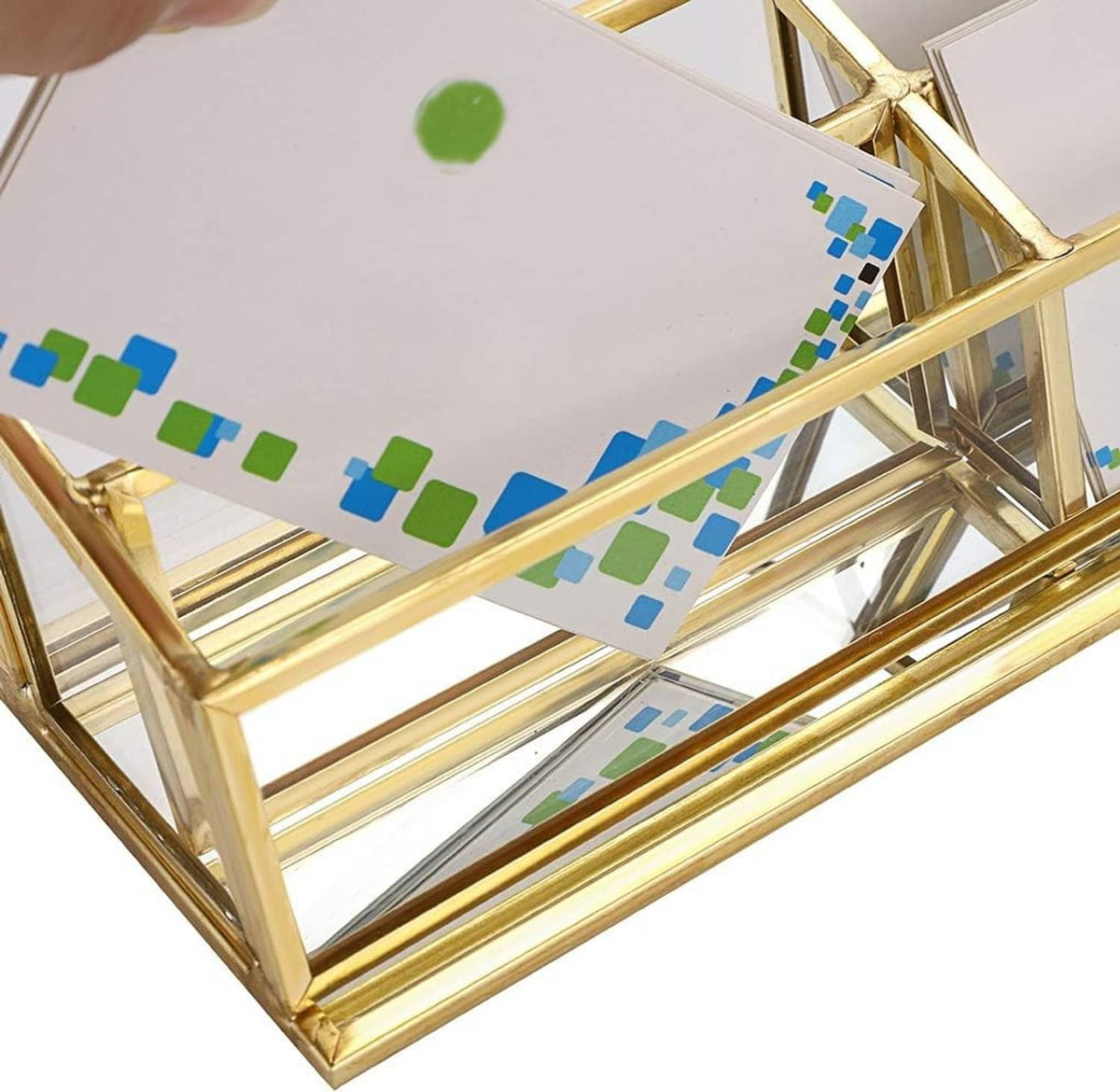 Close-up of gold 4-slot business card holder showing clear glass and printed cards