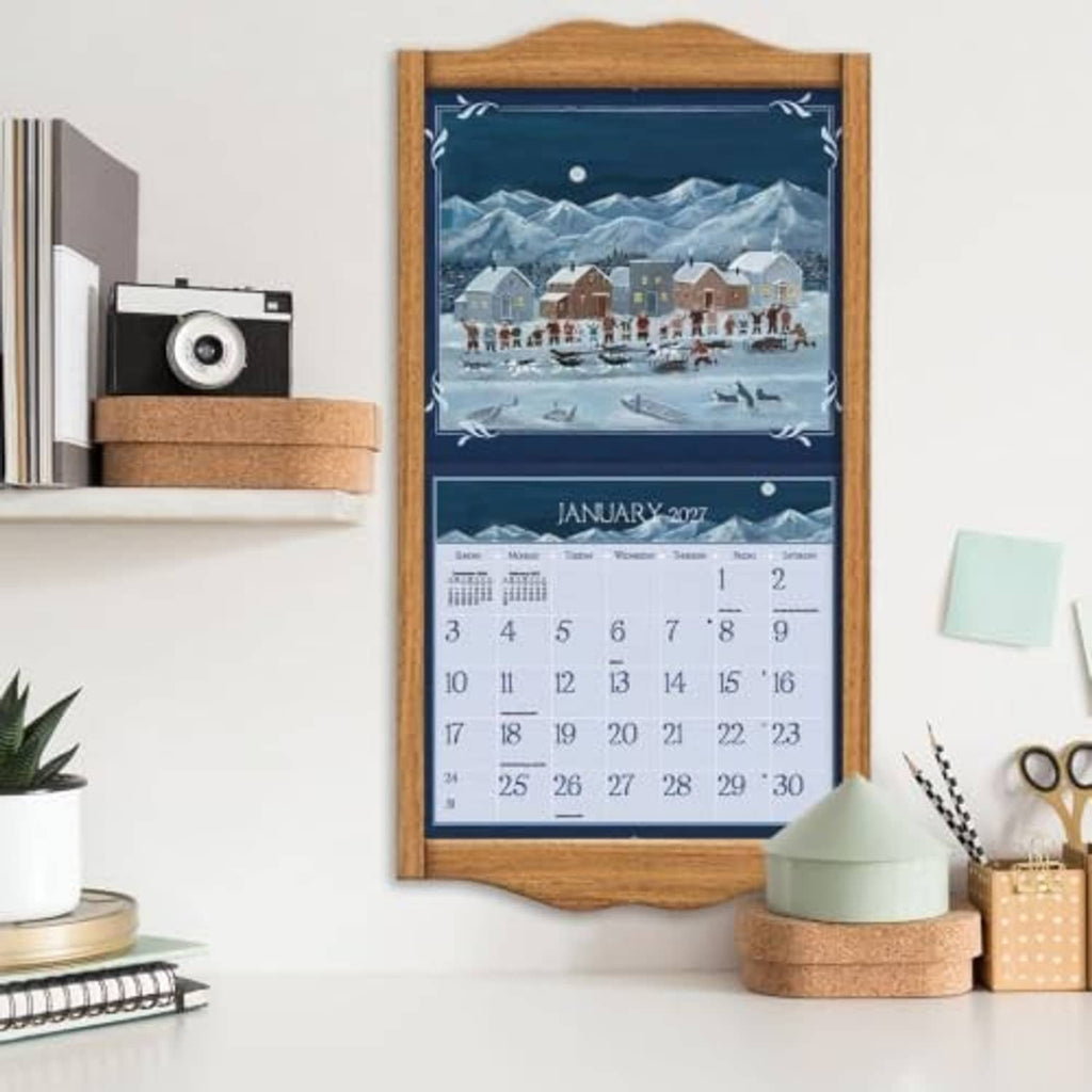LANG Folk Art 2027 wall calendar displayed in a wooden frame with January 2027 grid
