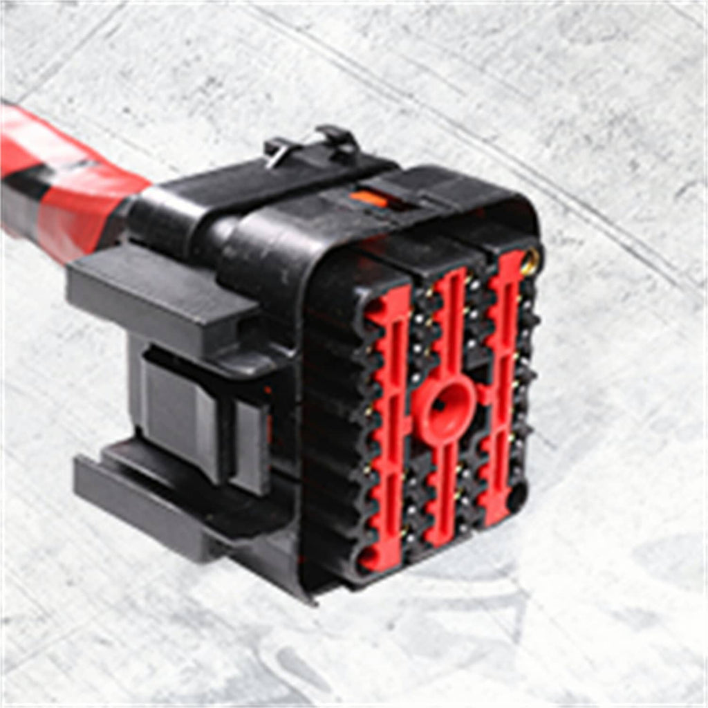 Electronic wiring connector module with multiple red terminal slots and black housing