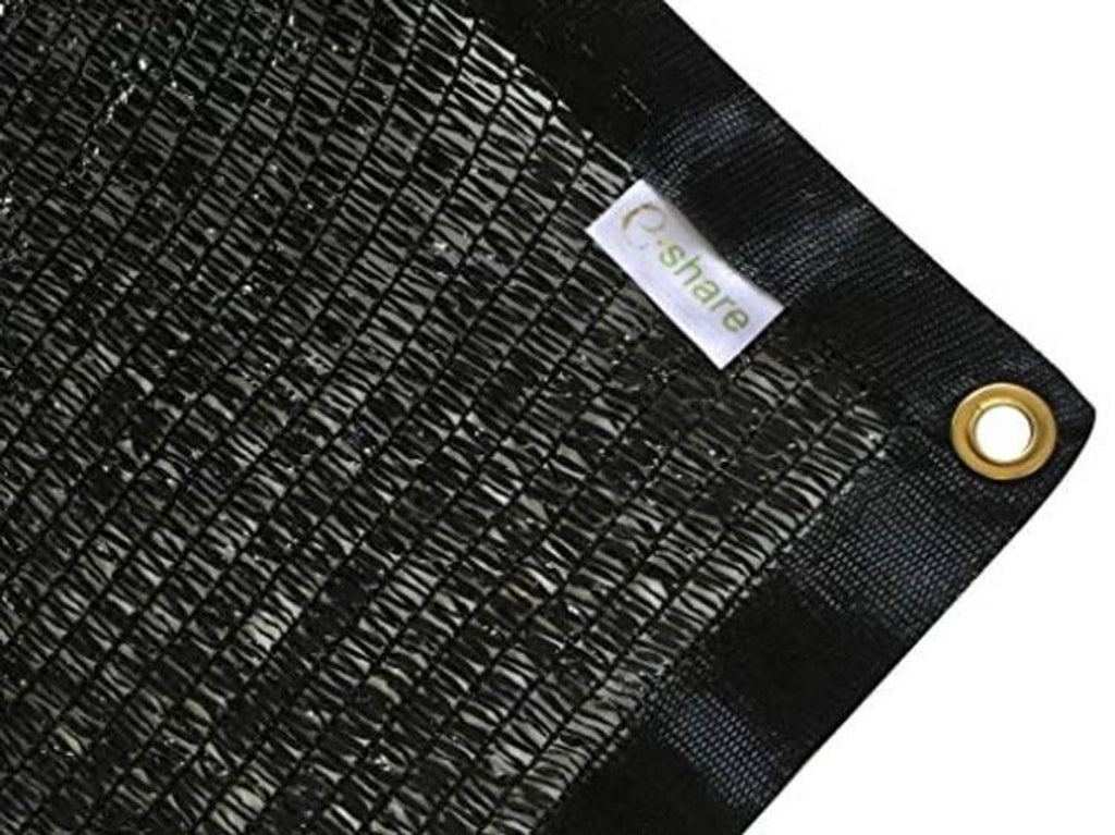 Black mesh shade fabric with brass grommet and corner reinforcement close-up