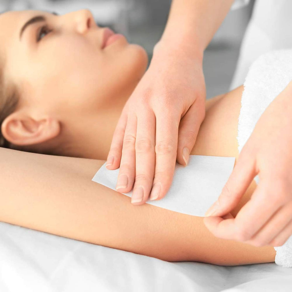 White non-woven epilating strip placement on arm