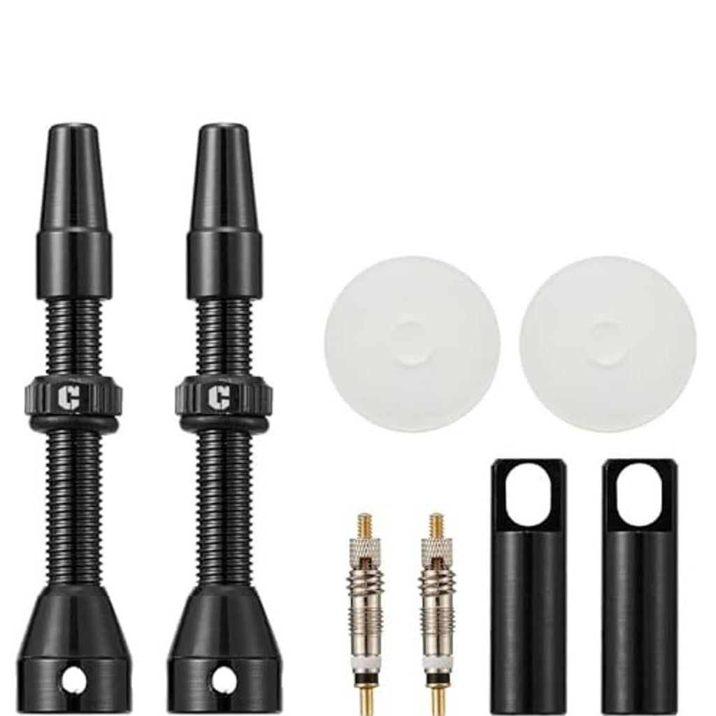 Black Presta tubeless valve stems with white sealing caps and spare metal cores