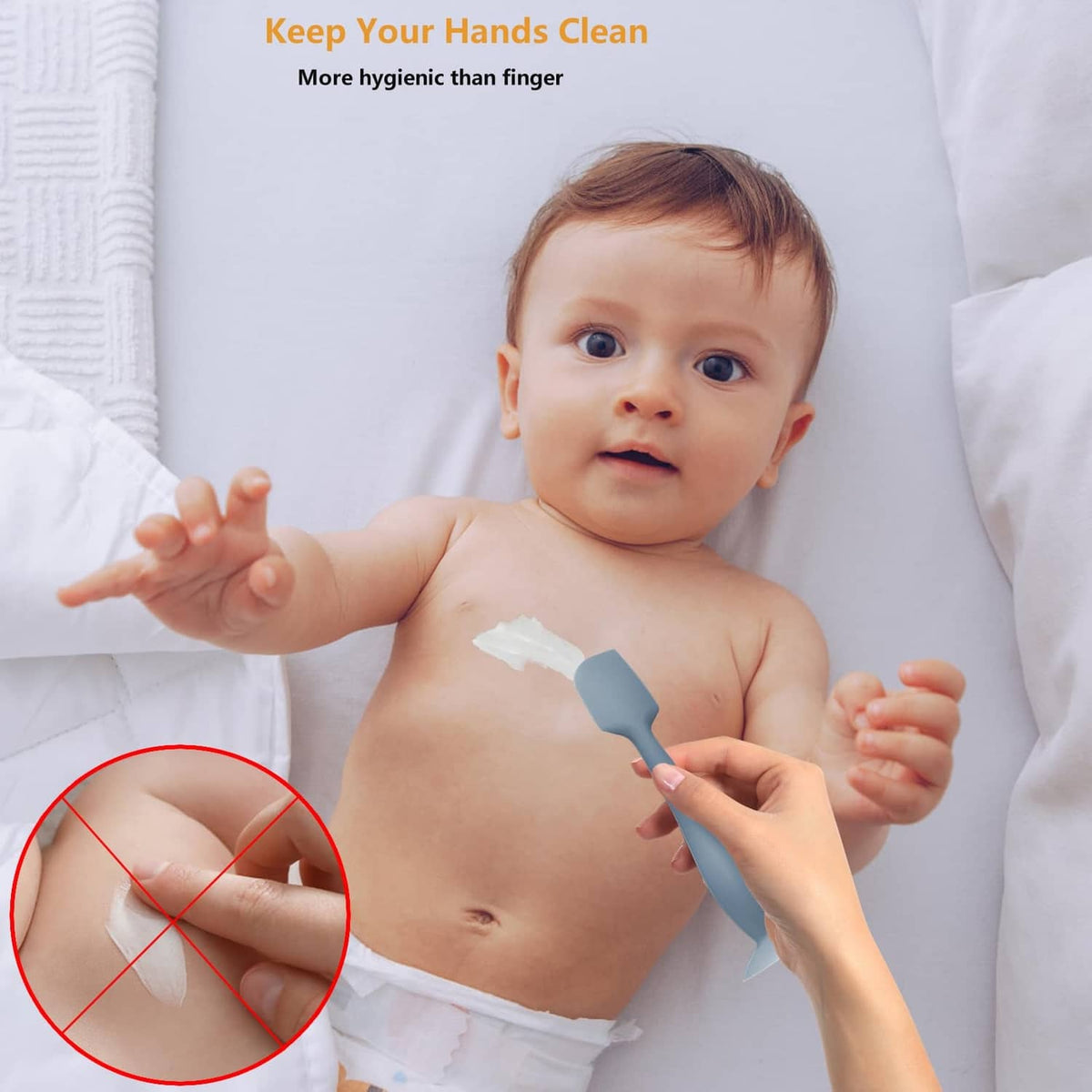 Dark blue silicone diaper cream spatula applicator spreading cream on baby skin