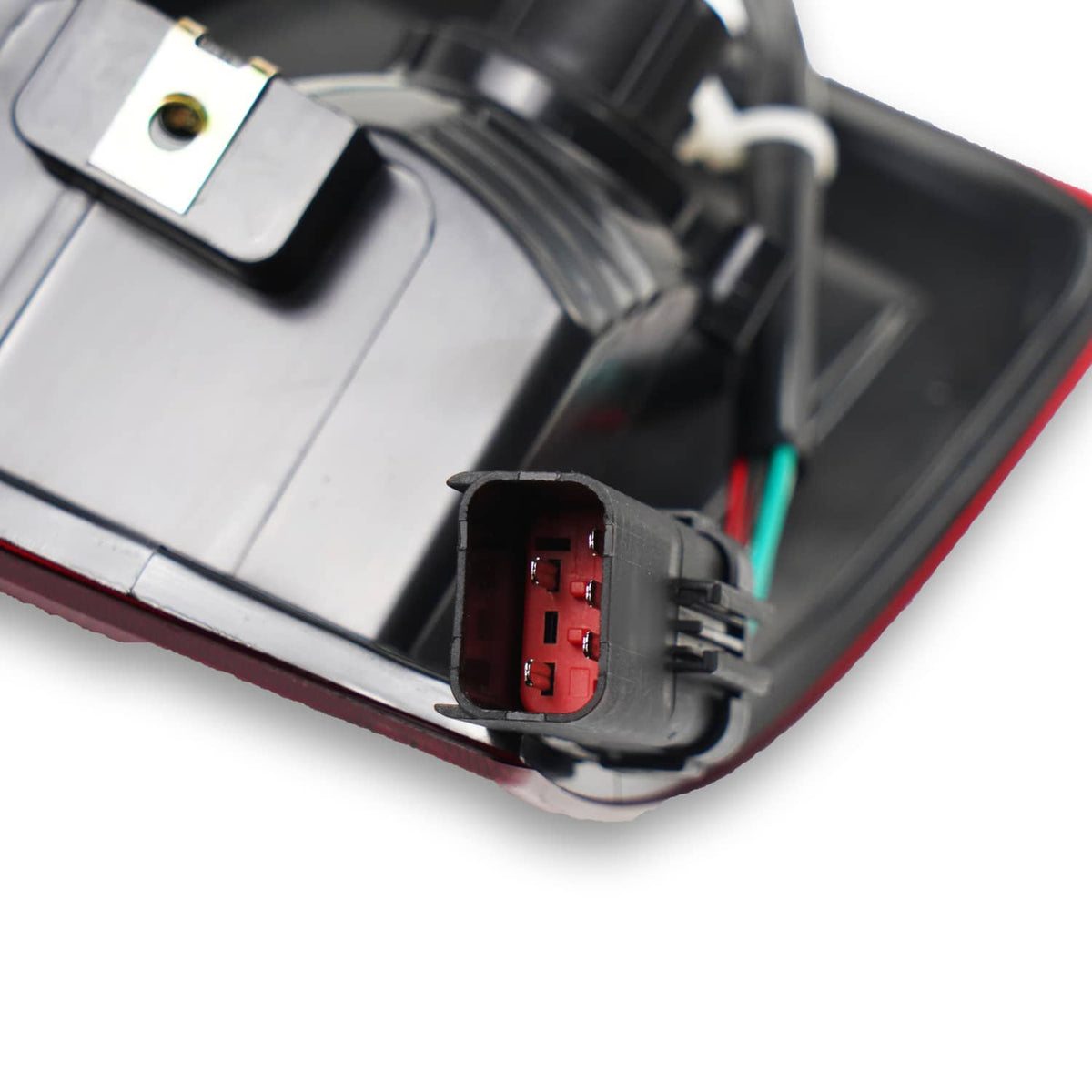 Close-up of tail light connector and wiring plug on red lamp housing