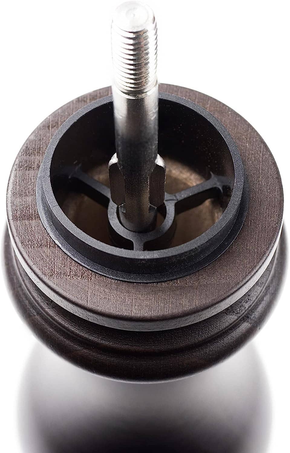 Pepper mill bottom close-up with central rod and grinding mechanism