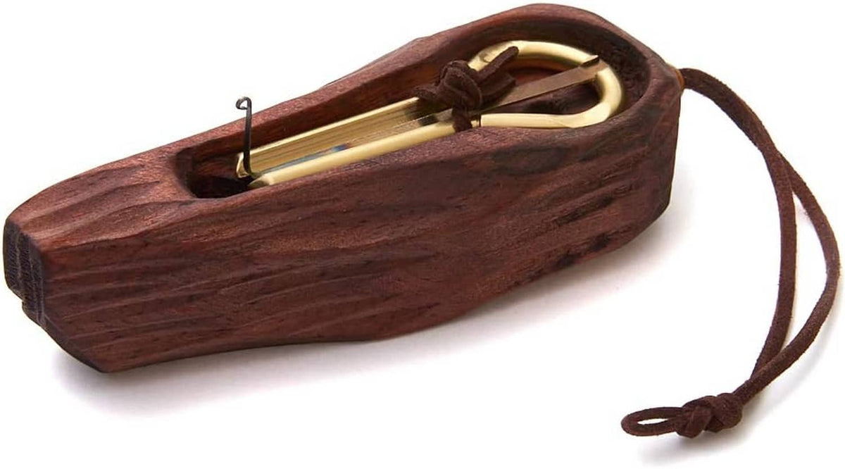 Brown open wooden case with gold-tone jew's harp mouth instrument and cord.