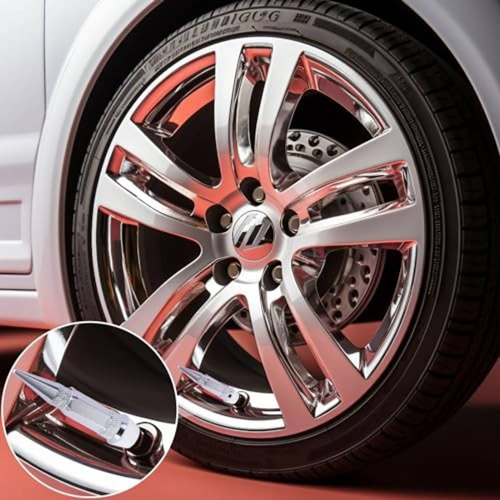 Spiked tire valve stem caps, silver, installed on a car wheel rim