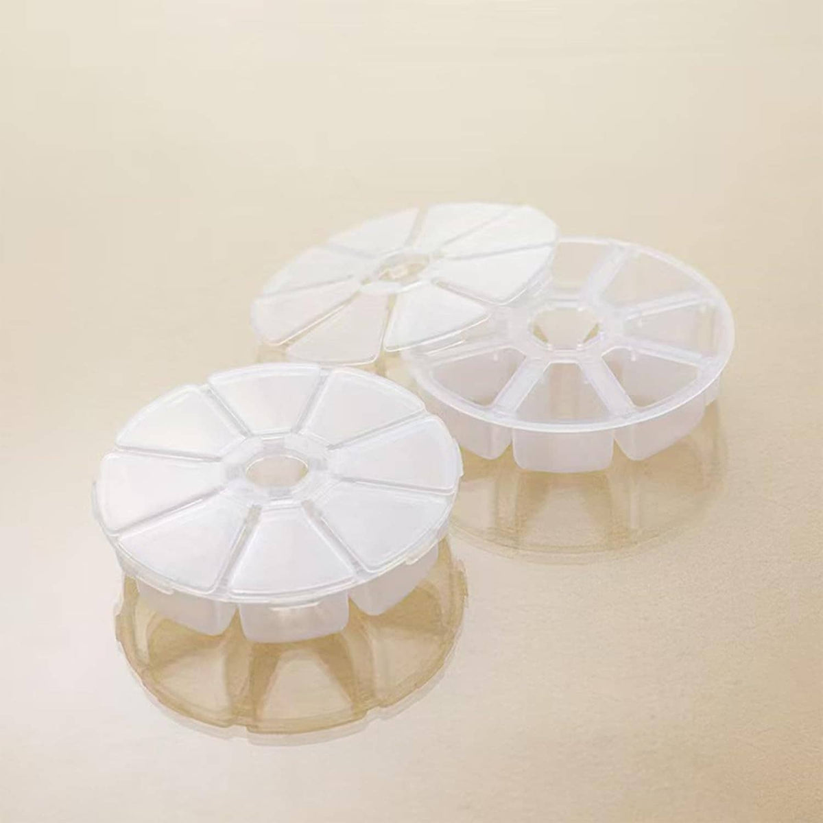 Two clear round jewelry bead storage boxes with 8 divided compartments each