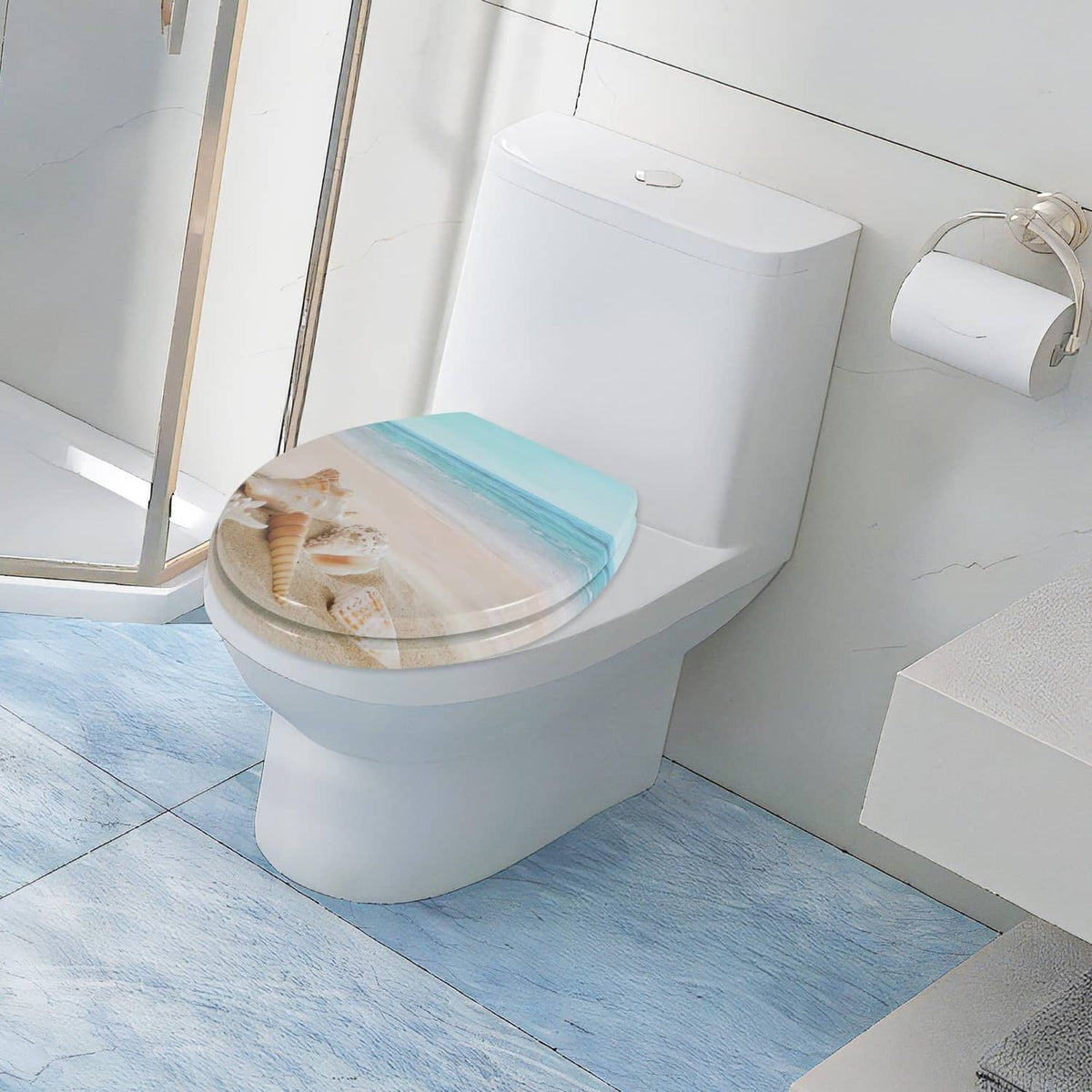 Round toilet seat with beach shell and ocean graphic, shown at an angled side view