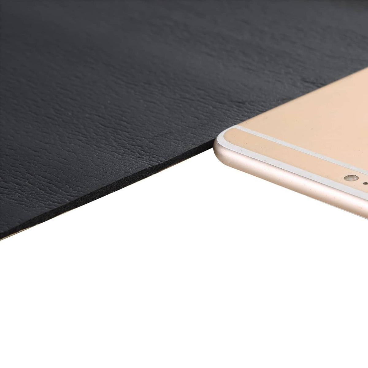 Close-up of dark gray neoprene foam rubber sheet edge and fine surface texture