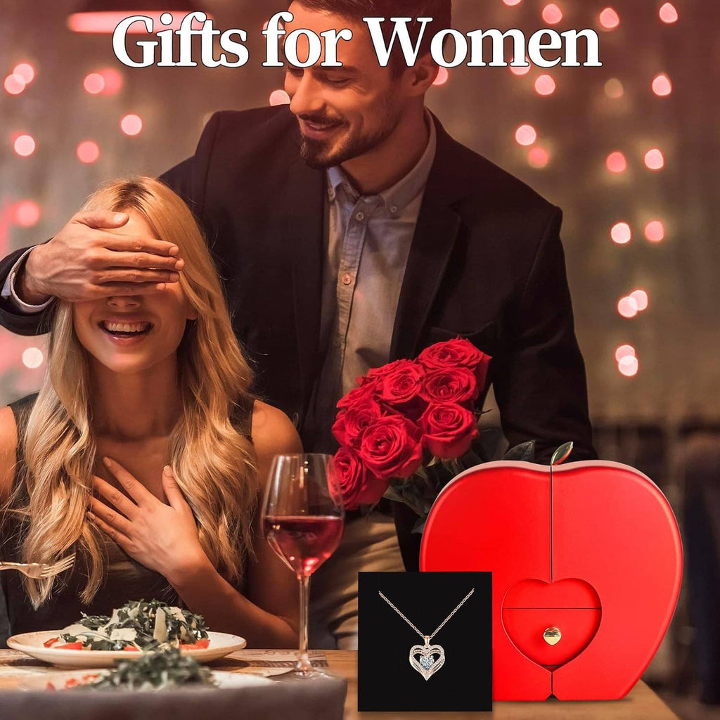 Woman and man at dinner with preserved red rose gift box and heart necklace