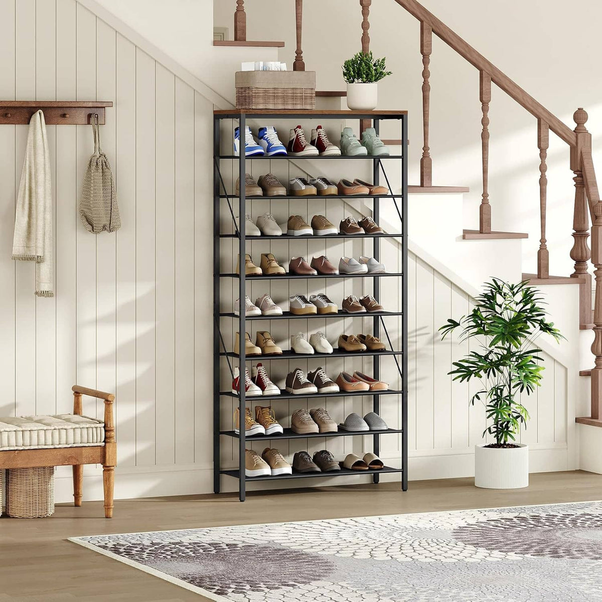Black metal 10-tier shoe rack organizer with gray shelves and wooden top, in entry closet.