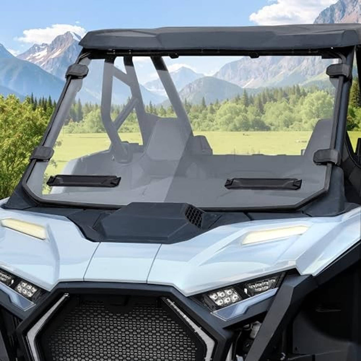 Front clear windshield panel with black side brackets on off-road UTV