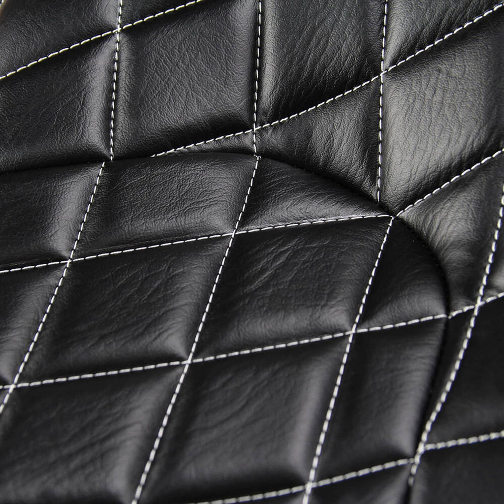 Close-up of black quilted seat cushion upholstery with white contrast stitching
